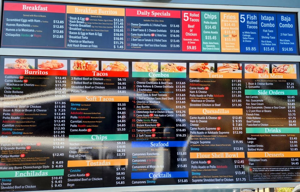 Drive-through window beside a casual storefront.
