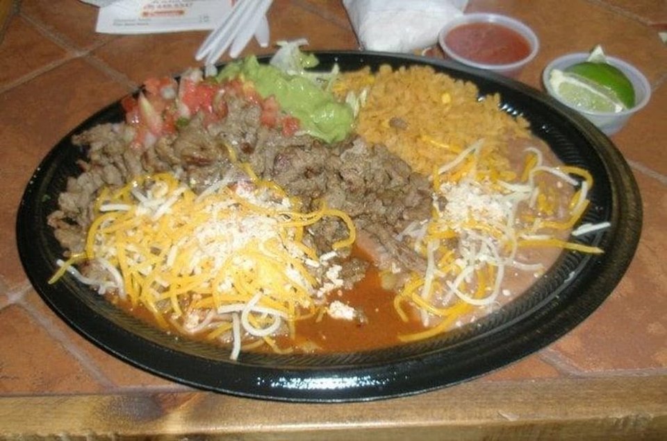Menu board with tacos and breakfast burritos.