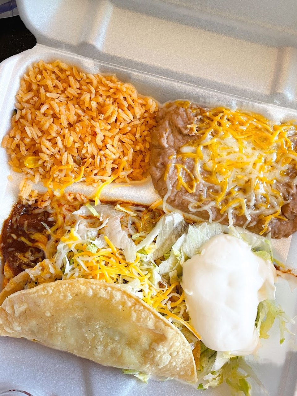 Printed menu showing burritos, tacos, and plates.