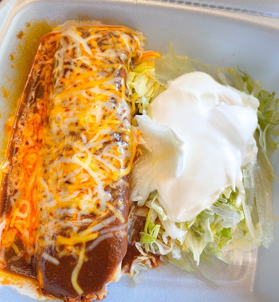 Printed menu showing burritos, tacos, and plates.