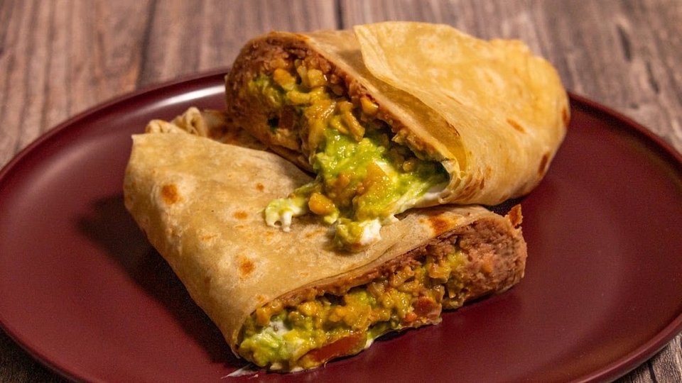 Printed menu showing burritos, tacos, and plates.