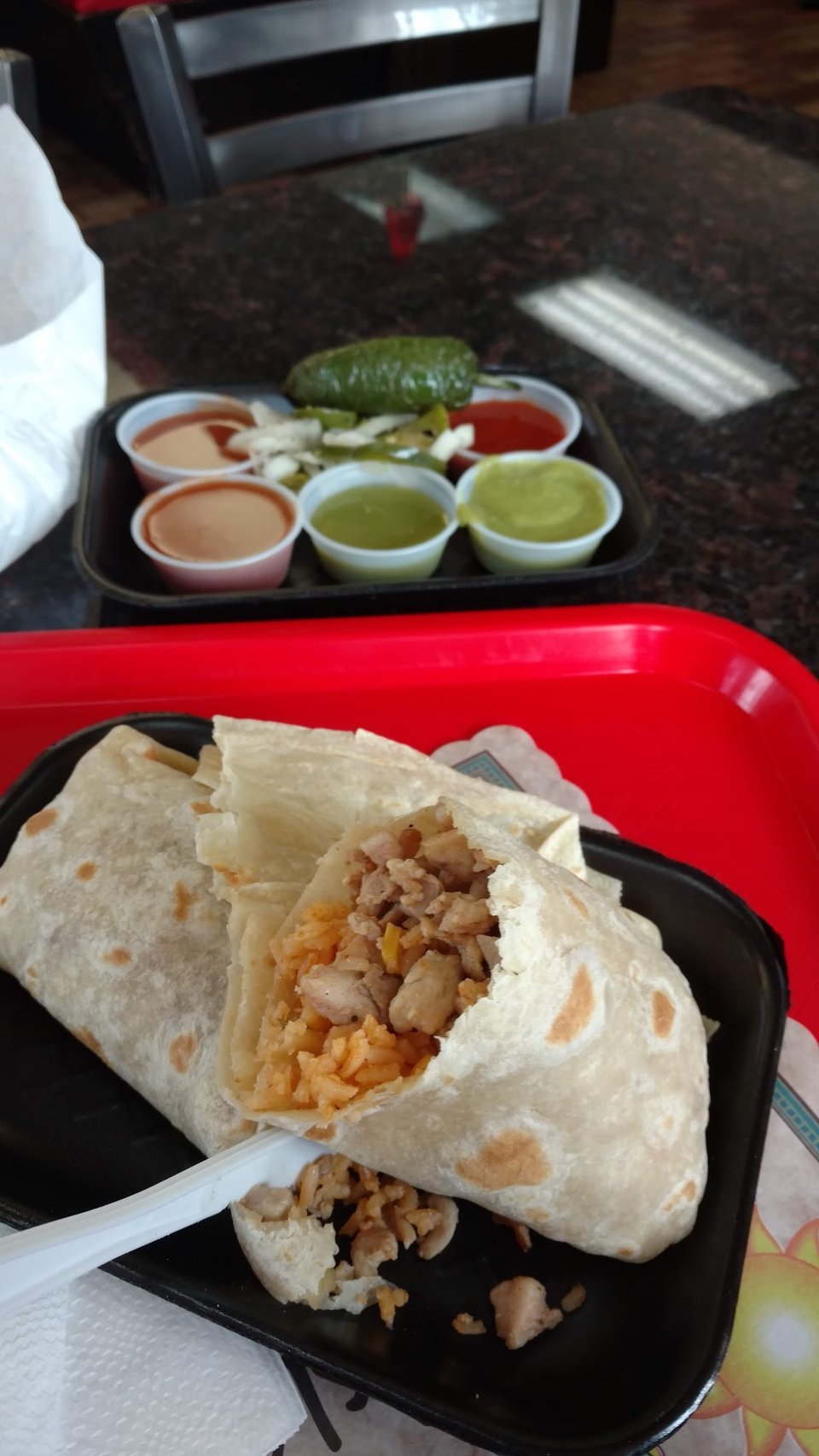 Menu board with tacos and breakfast burritos.