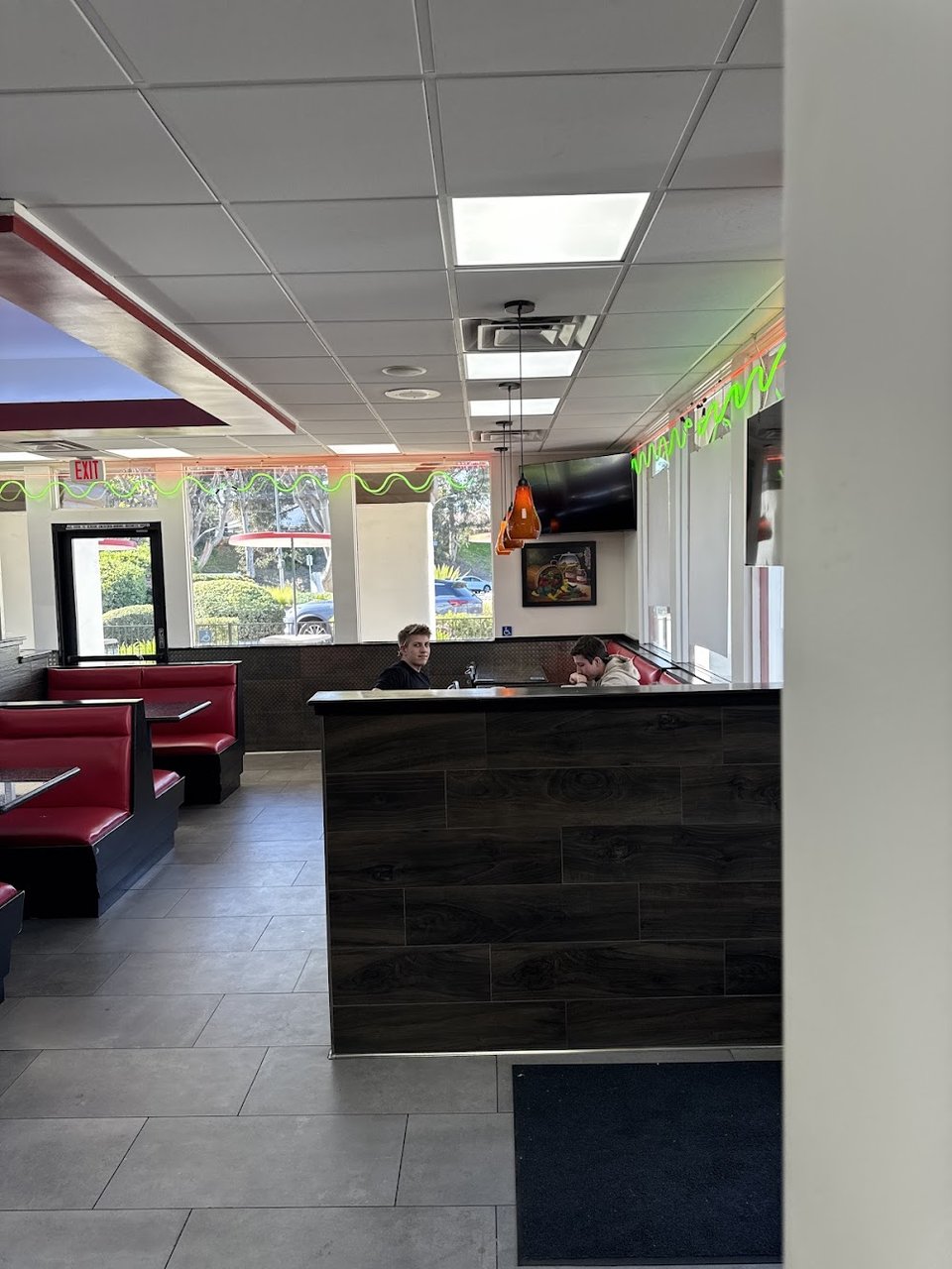 Printed menu showing burritos, tacos, and plates.